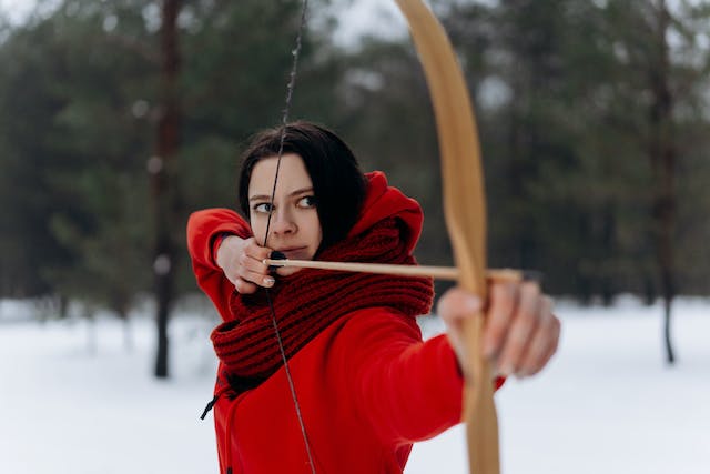 Photo by Mikhail Nilov: https://www.pexels.com/photo/woman-in-red-jacket-shooting-a-bow-and-arrow-6620577/
