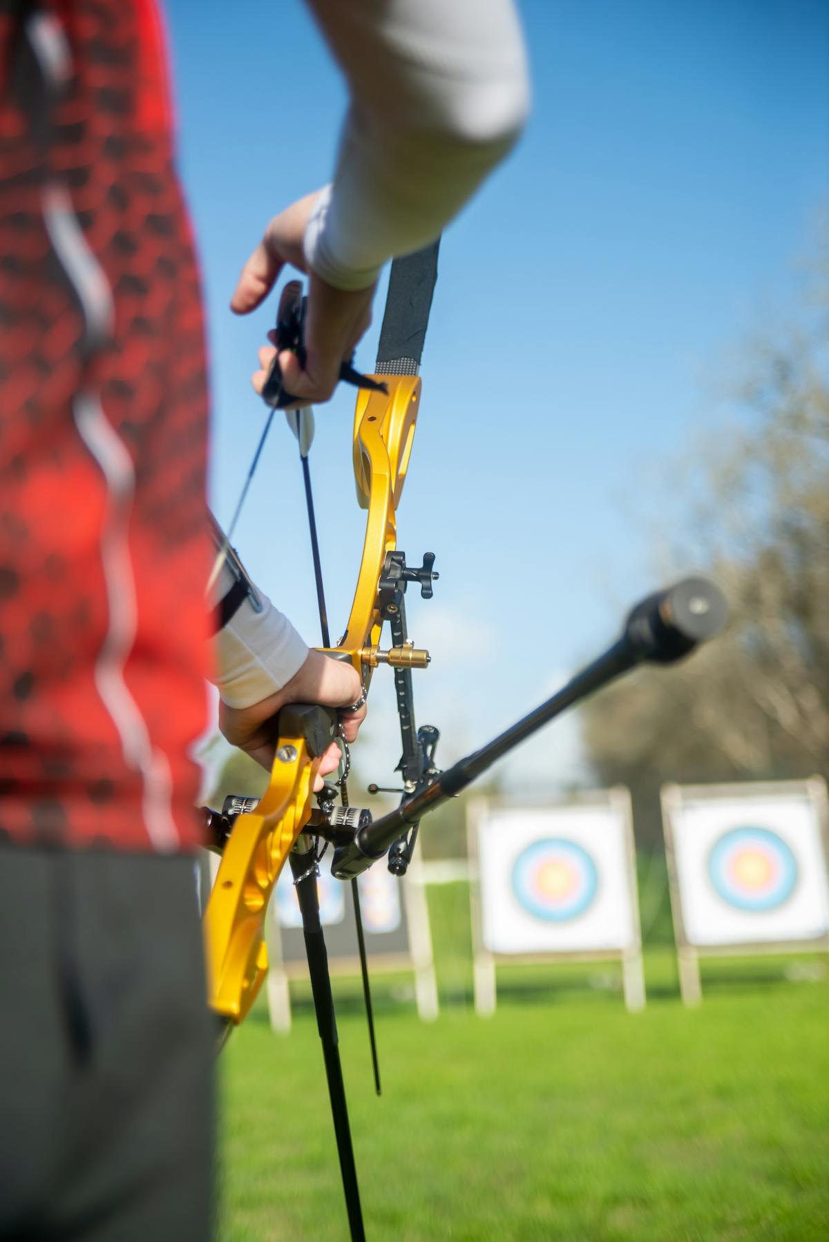 Archer focused on hitting target during outdoor practice verifying compound bow tune accuracy