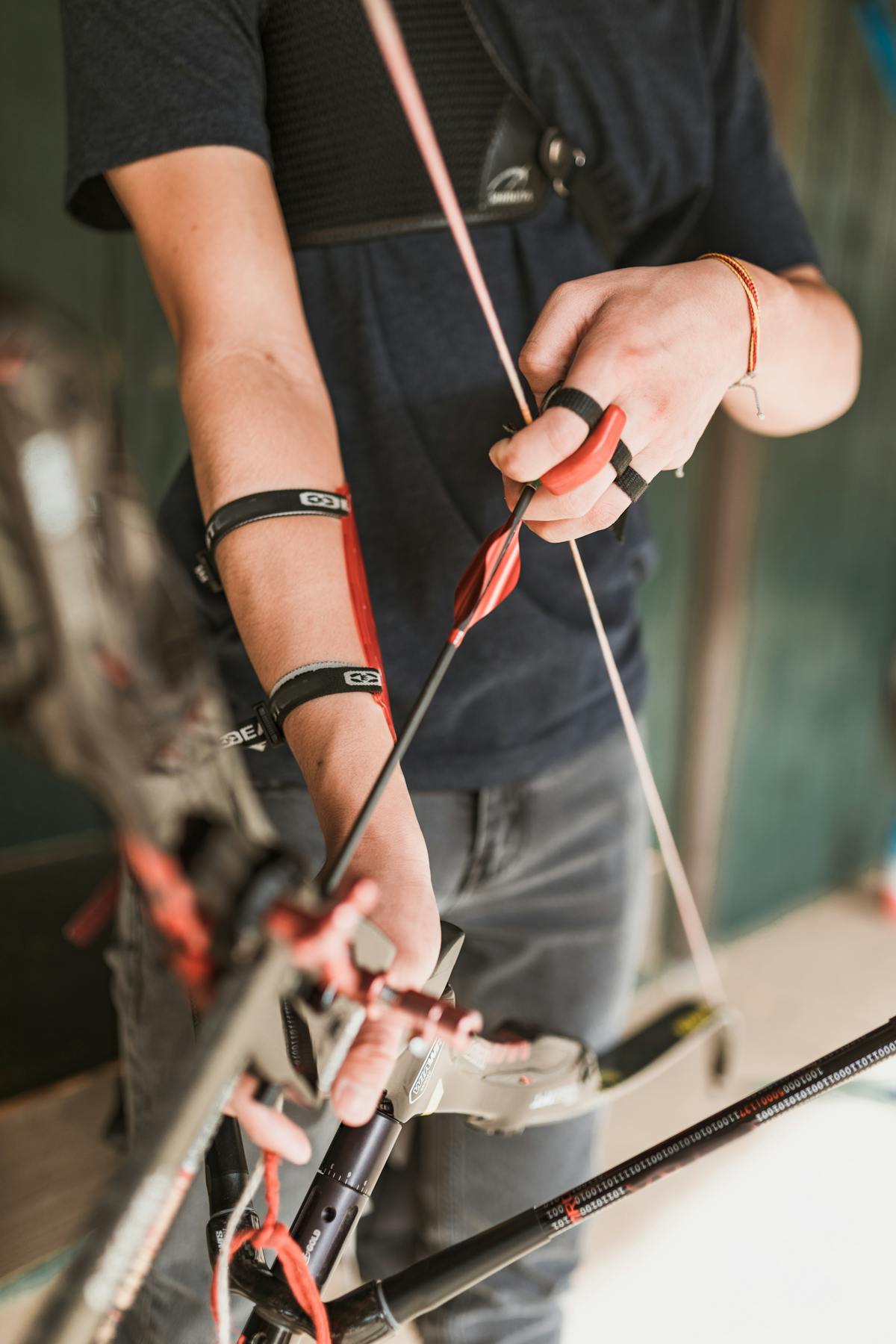 Focused archer nocking an arrow on a compound bow for proper arrow rest alignment