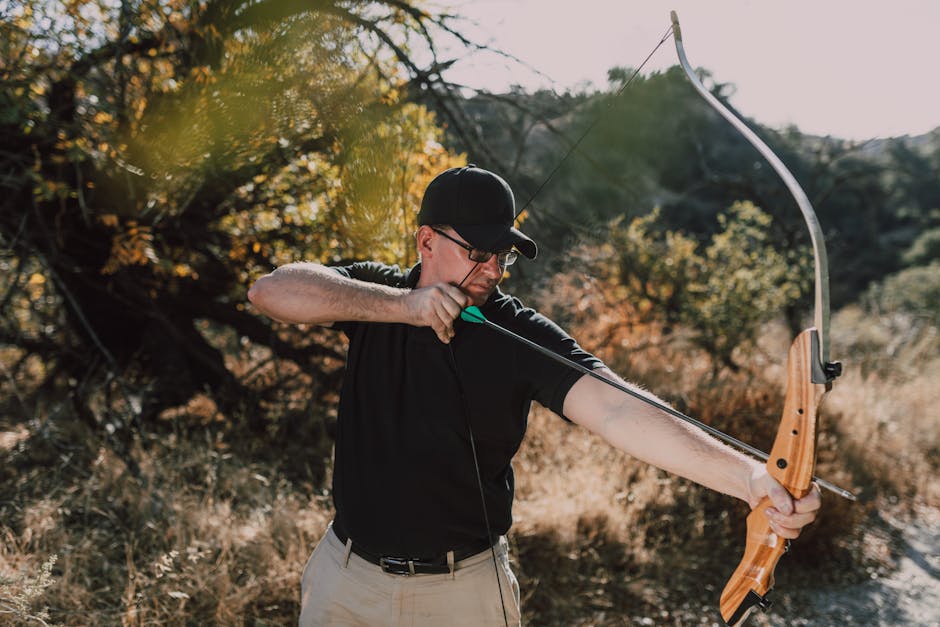 archer practicing with recurve bow outdoors beginner bow buying guide