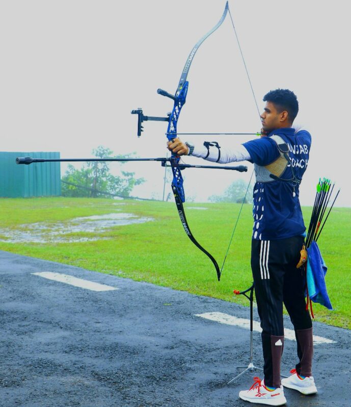 Archer demonstrating proper archery posture and stance with recurve bow at full draw