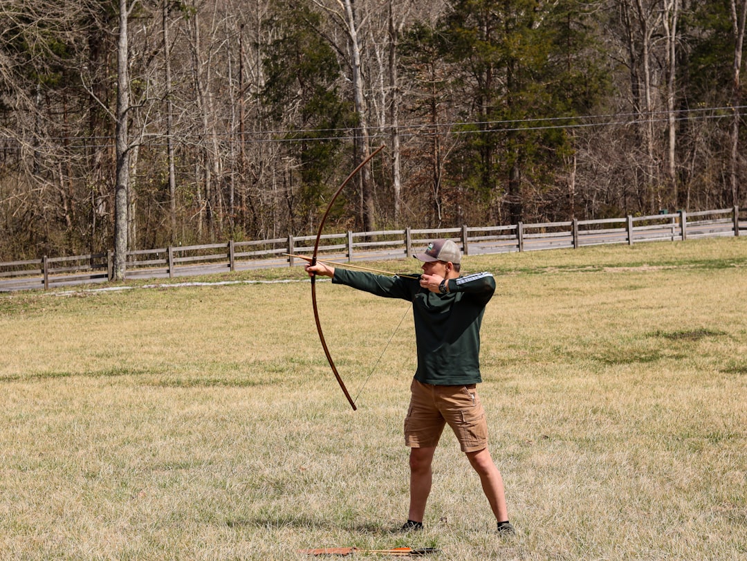 Archer releasing arrow showing proper follow-through technique