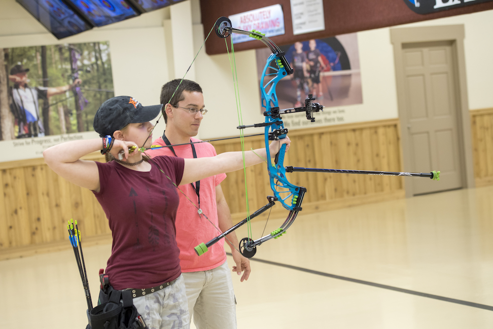 Archer practicing target shooting with properly measured draw length for accuracy