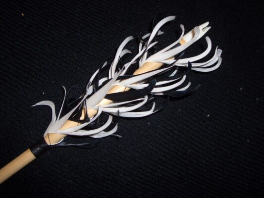 Arrow fletching guide - feather fletching close up on arrow shaft