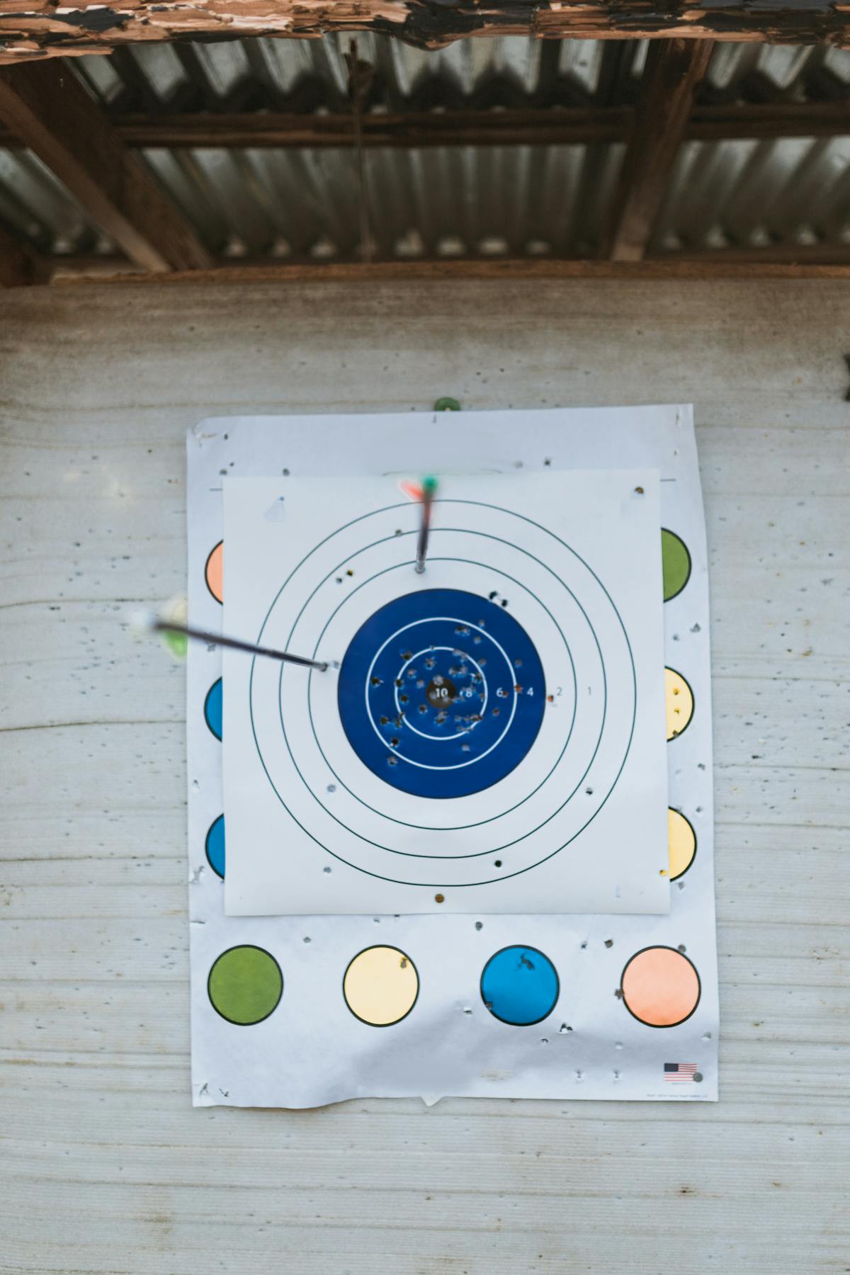 Arrows grouped tightly in an archery target showing accurate arrow spine selection results