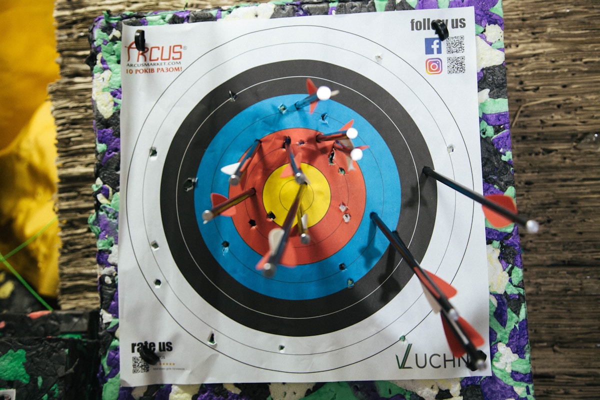 Arrows grouped tightly in target bullseye showing results of well-tuned compound bow