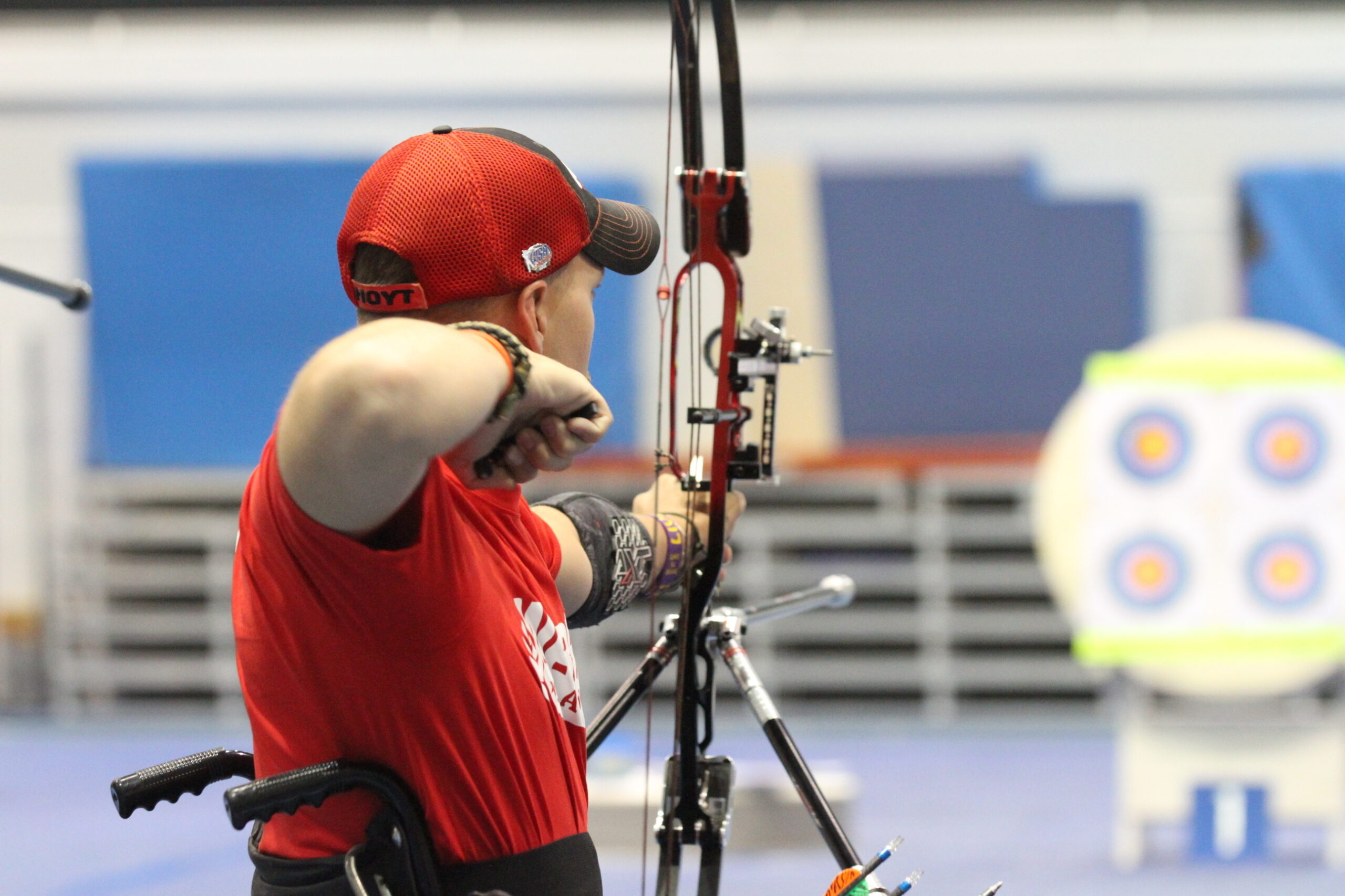 Compound bow archer using release aid at full draw during competition