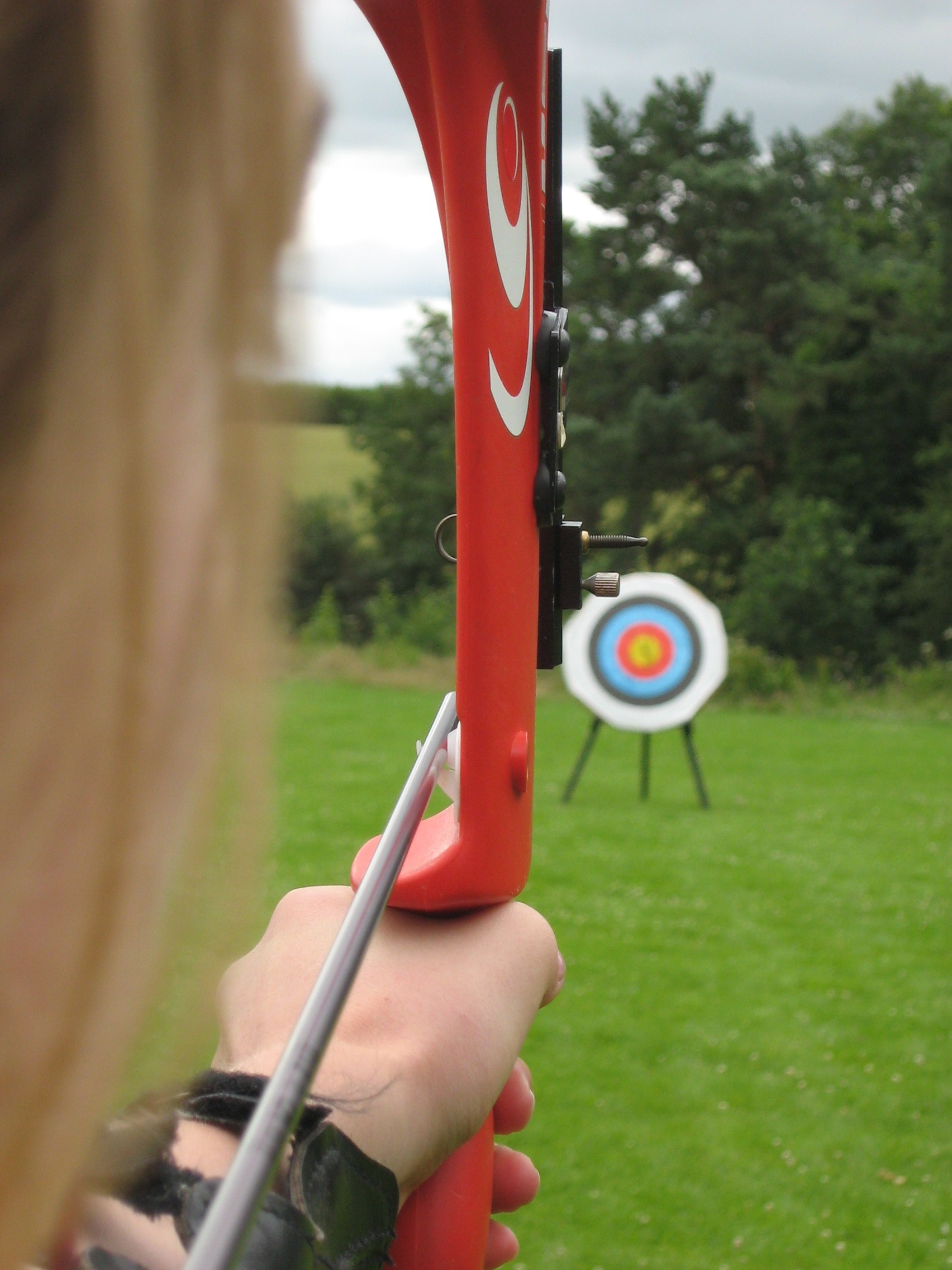 Compound bow target shooter demonstrating proper form with release aid