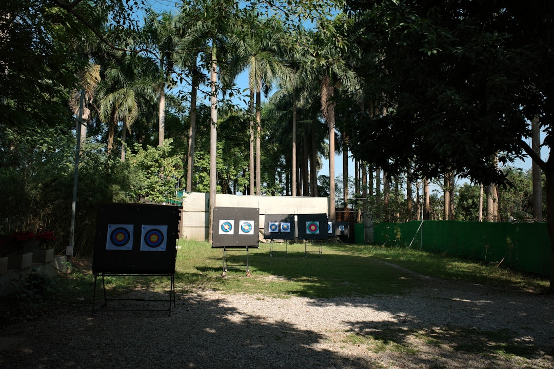 Outdoor archery target practice range with bullseye targets on grass field