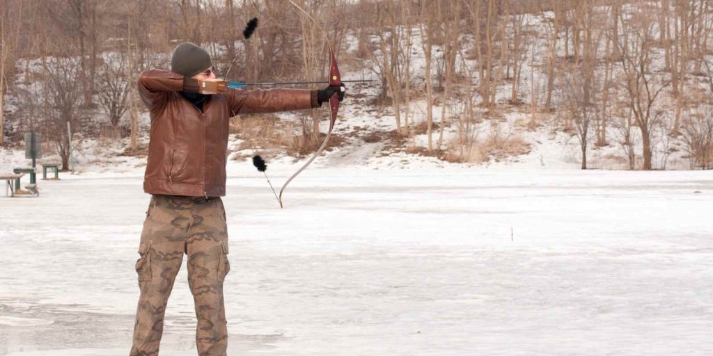 Recurve archer at full draw practicing bow tuning adjustments
