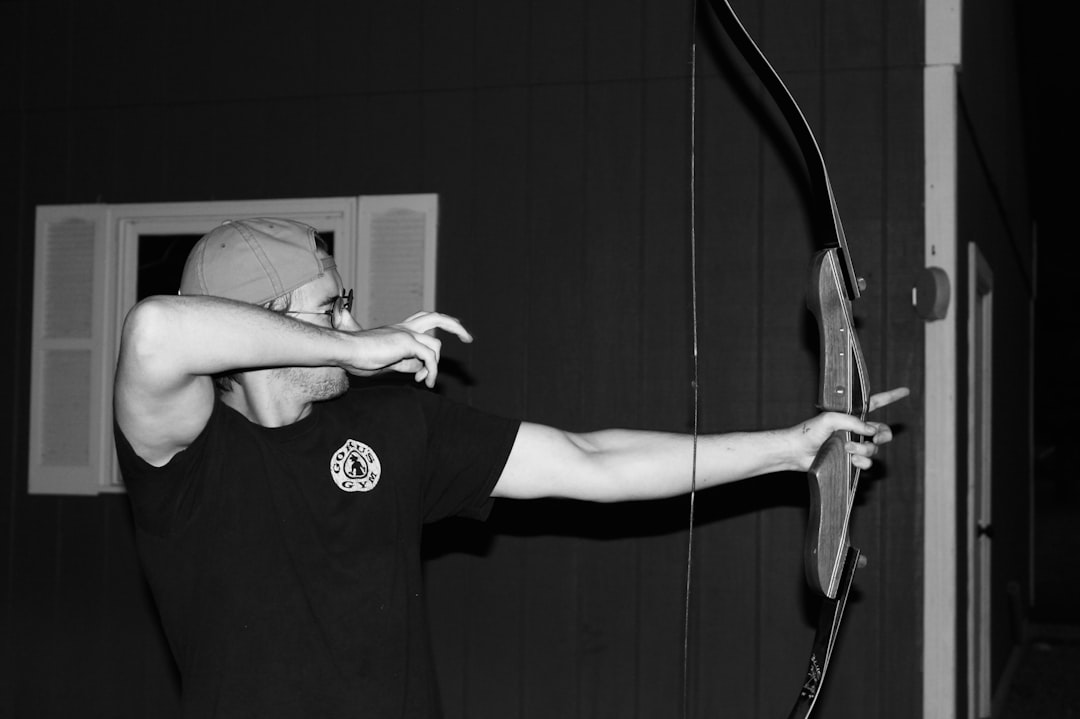 Recurve bow archer aiming during competitive sport event like India para archery awards