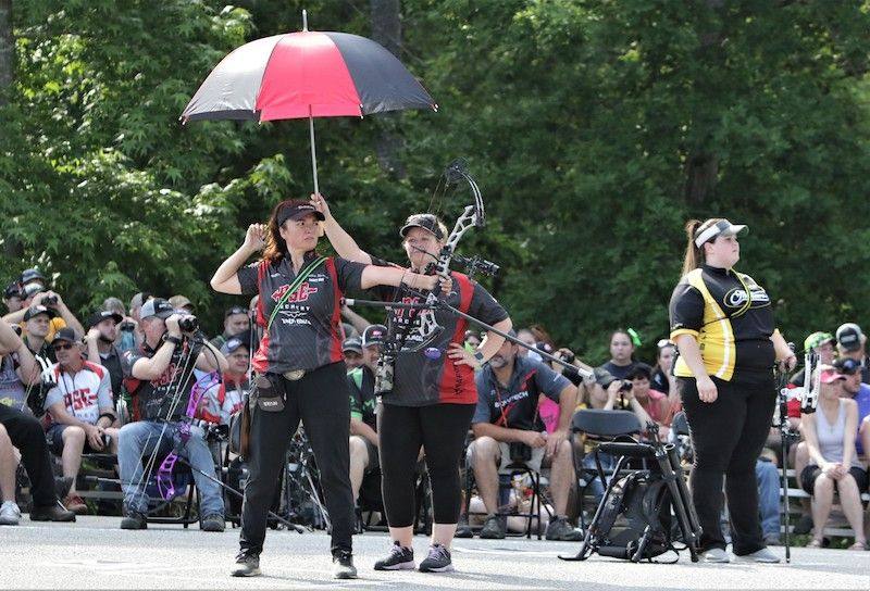 Archers competing at a 3D archery tournament outdoors