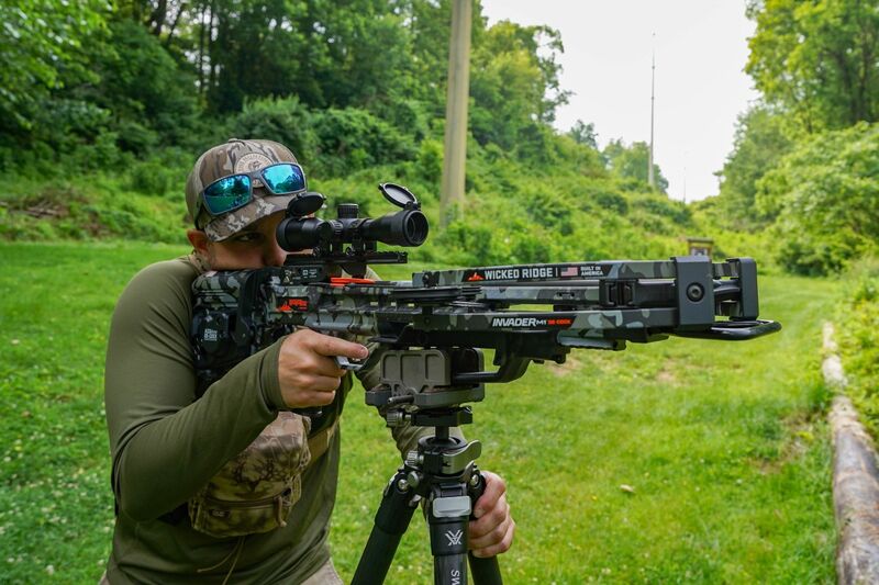 Archery hunting gear setup showing arrows and crossbow equipment for different game