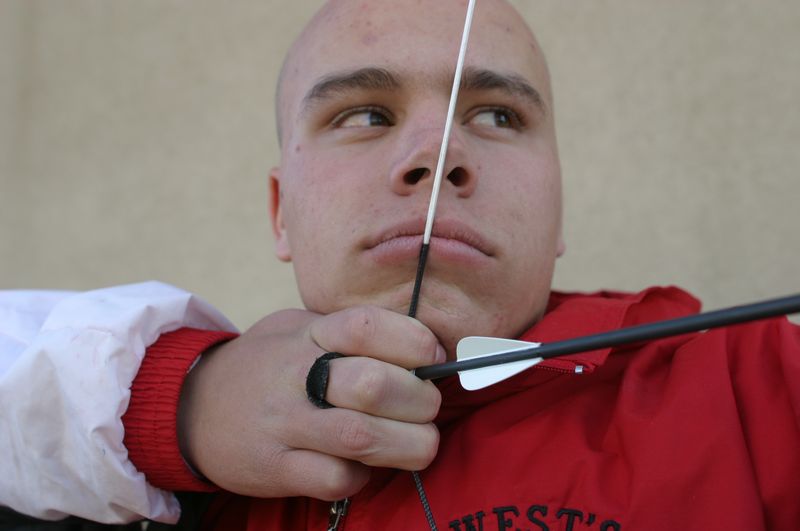 archer at full draw showing arrow spine flex