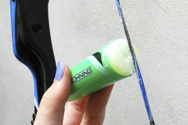 Applying bow string wax to extend life before bow string replacement