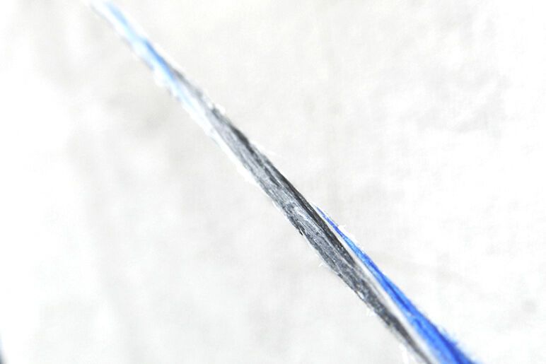 Close-up of bow string fibers showing wear that signals replacement