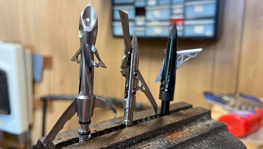 Three broadheads displayed on a wood block during broadhead tuning test setup