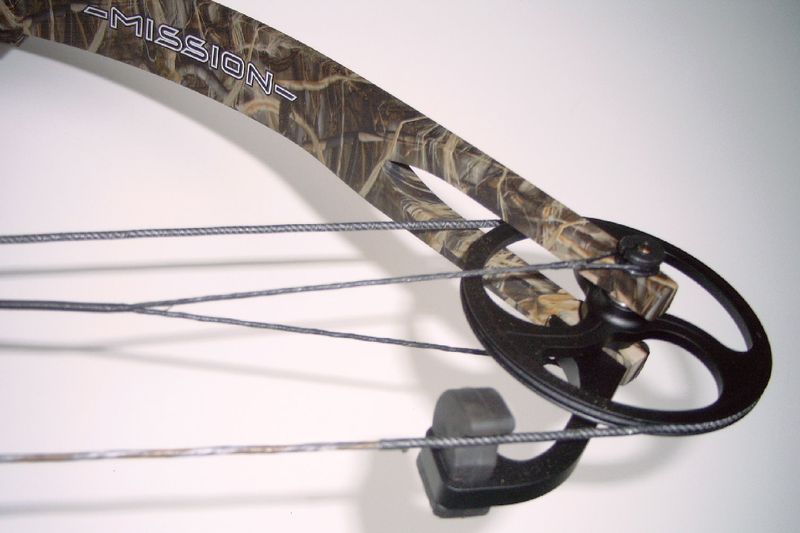 Compound bow idler wheel and cable stop creating the back-wall feel