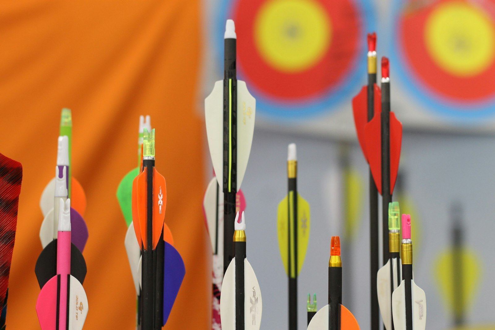 Compound and recurve arrows with colorful fletchings ready for championship competition