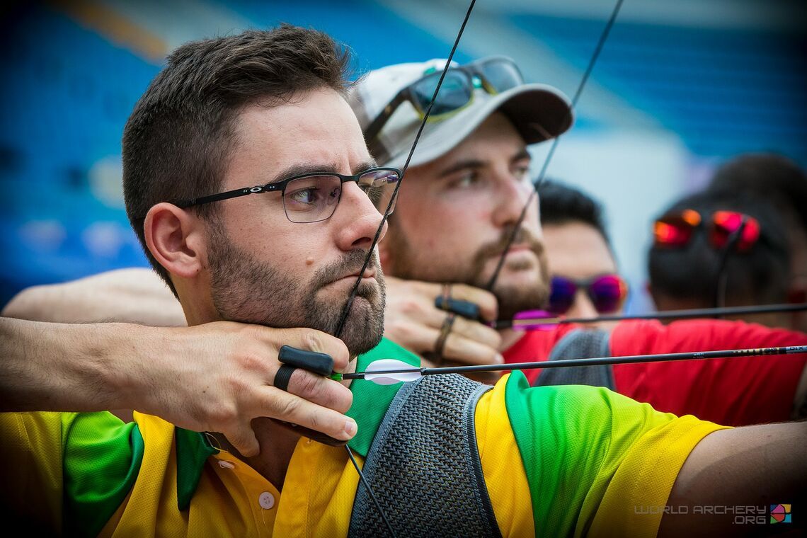 Recurve archer wearing glasses sights down the arrow to confirm dominant eye in archery