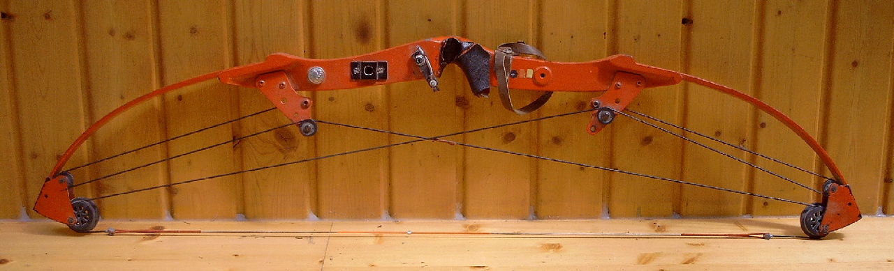 Compound bow hunter in a treestand using a hybrid slider bow sight