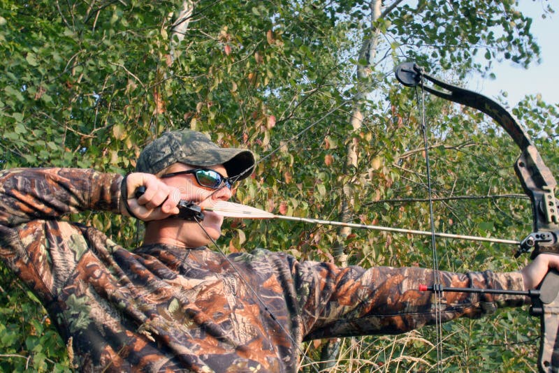 Bow hunter pulling back compound bow. Compound bow stock images, royalty-free photos and pictures