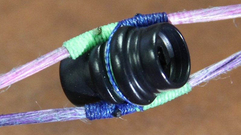 Finished peep sight installation with green and blue serving thread alignment view