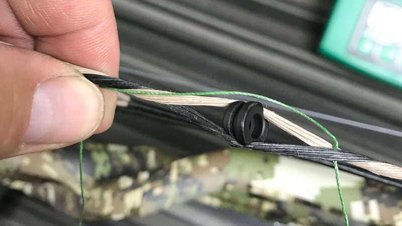 Separating bow string strands during peep sight installation on a compound bow
