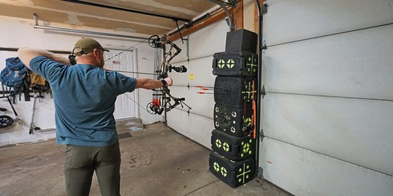 Compound bow archer at full draw practicing target panic drills