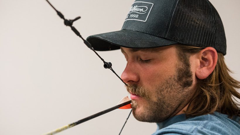Archer anchored at full draw with a release hooked to the D-loop