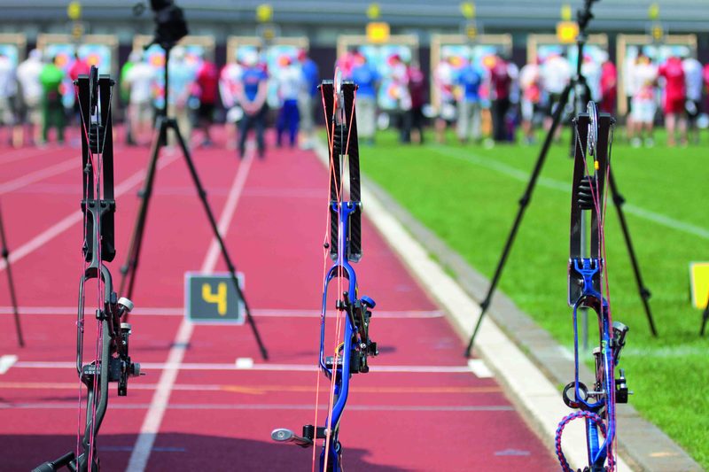 Row of recurve bows on the shooting line at a target range
