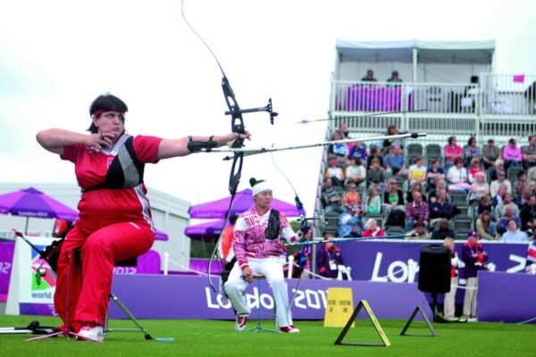 Recurve archer at full draw demonstrating the archer's paradox