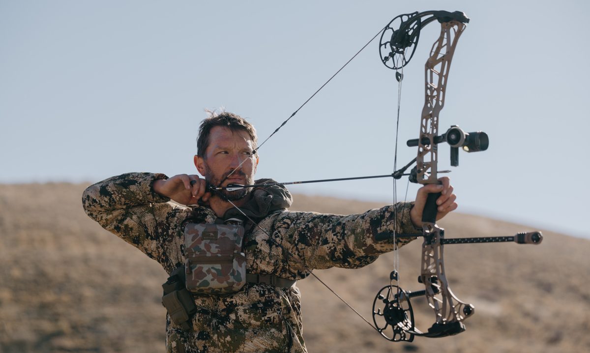 Bowhunter at full draw using an archery release aid on a compound bow