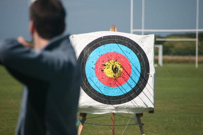 Archer practicing shot placement at a 3D archery target