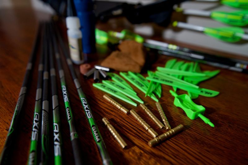 Carbon arrow shafts inserts nocks and fletching laid out before cutting to length