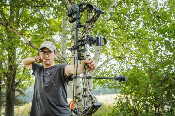 Bowhunter at full draw with compound bow tuned for arrow FOC