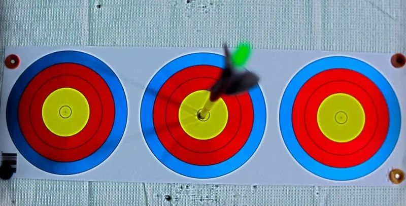Carbon arrow with proper spine hitting yellow center ring on archery target