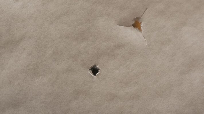 Bareshaft tuning tear pattern showing fletched and bare shaft impact through paper