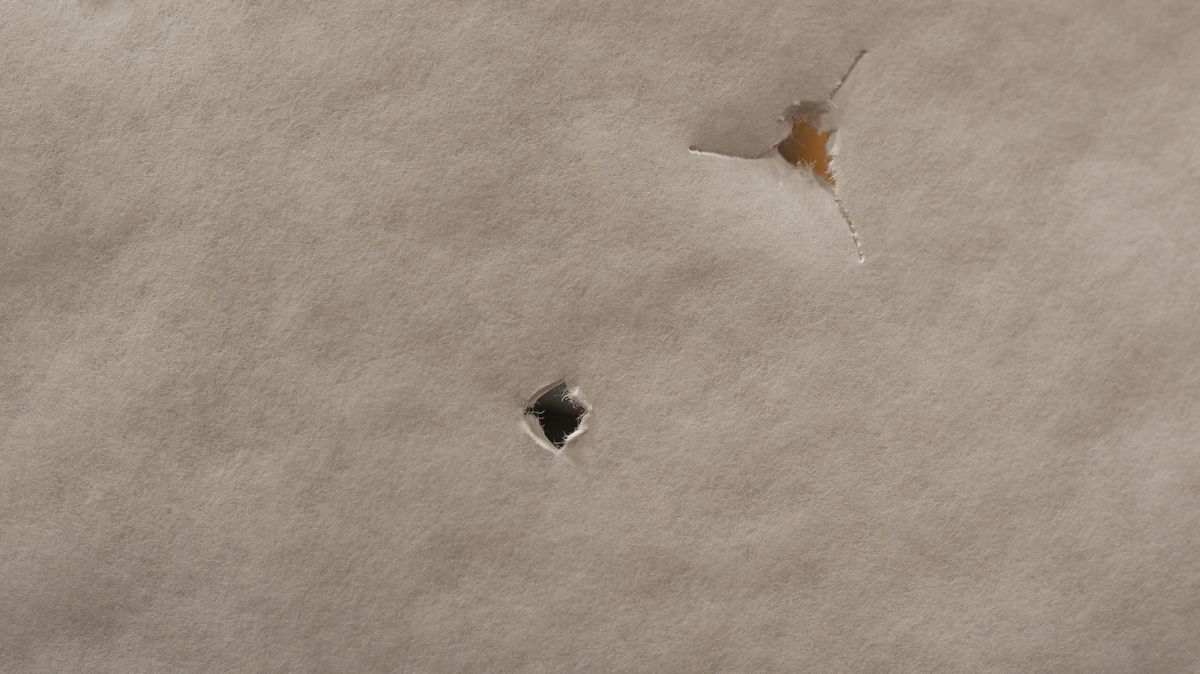 Bareshaft tuning tear pattern showing fletched and bare shaft impact through paper