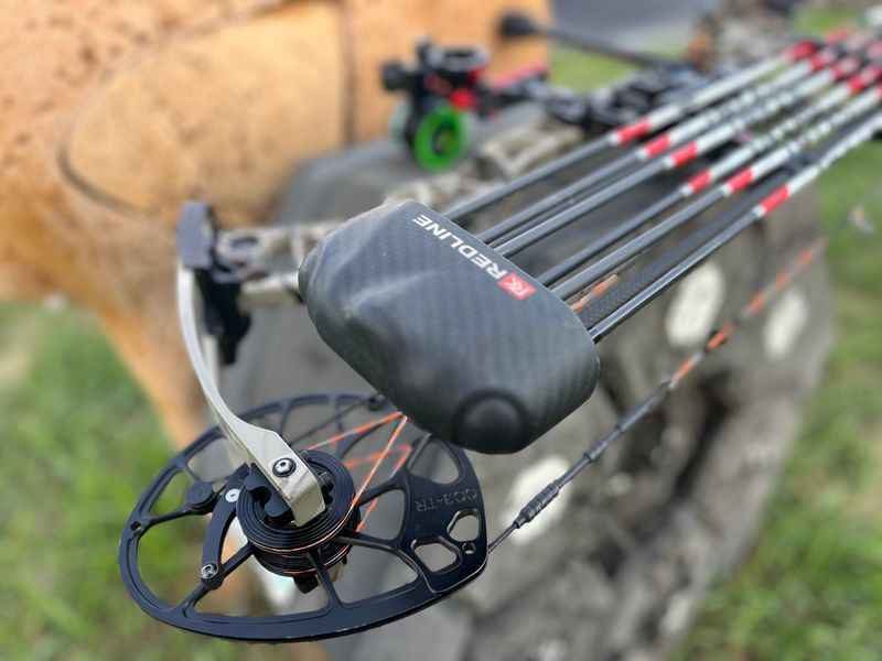 bow-mounted quiver close-up on compound bow with broadheaded arrows