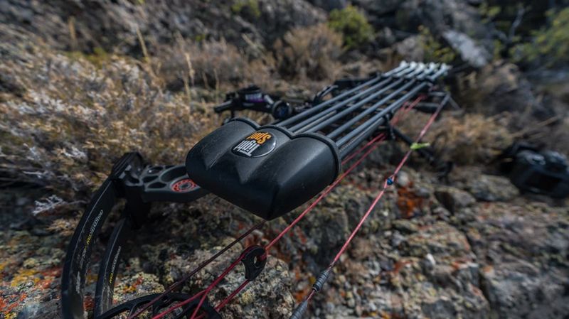 bow-mounted TightSpot quiver on compound bow in mountain hunting terrain