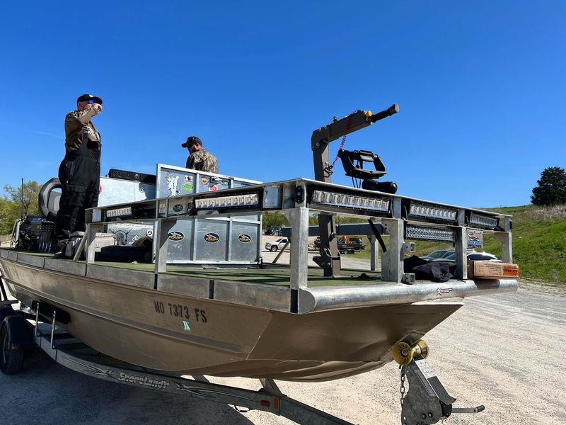 Bowfishing boat with elevated shooting platform