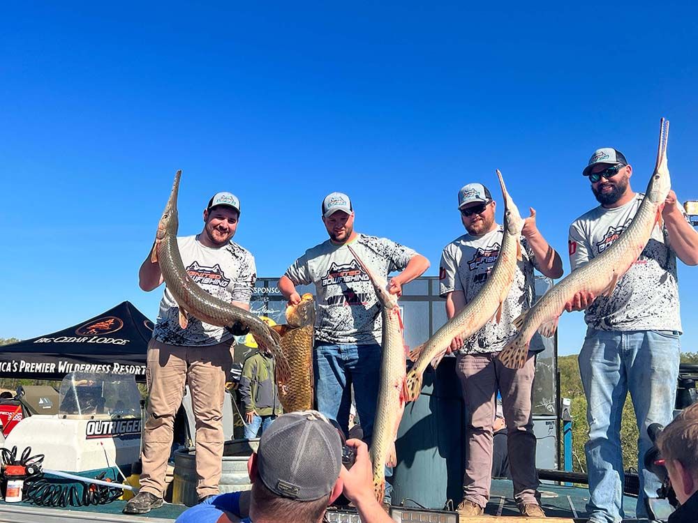 Bowfishing tournament team holding alligator gar