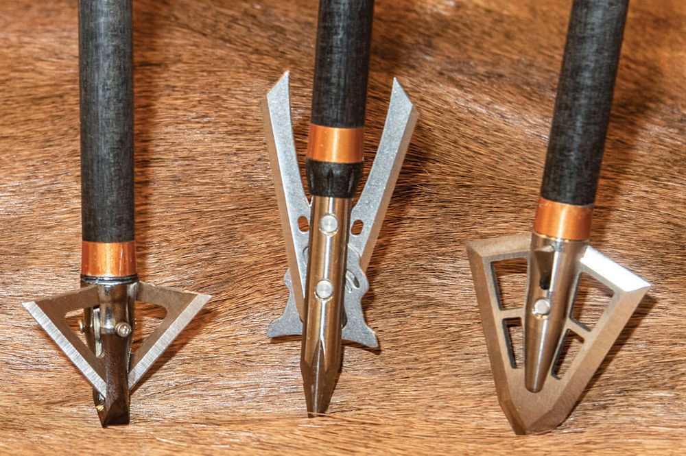 Bowhunter choosing between mechanical and fixed blade broadheads in the field