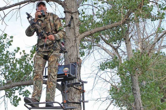 Bowhunter using compound bow from tree stand for deer hunting at proper draw weight