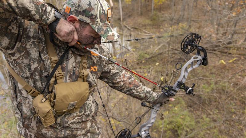 Bowhunter at full draw demonstrating treestand anchor point