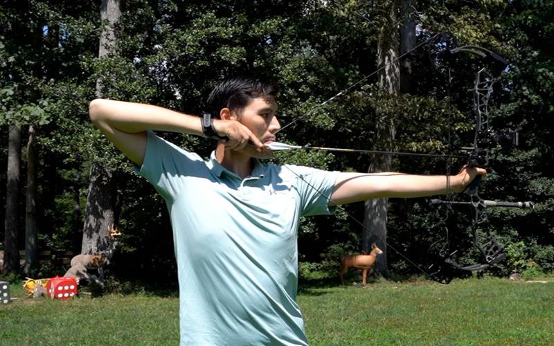 Archer reaching anchor point at full draw showing hunting draw weight