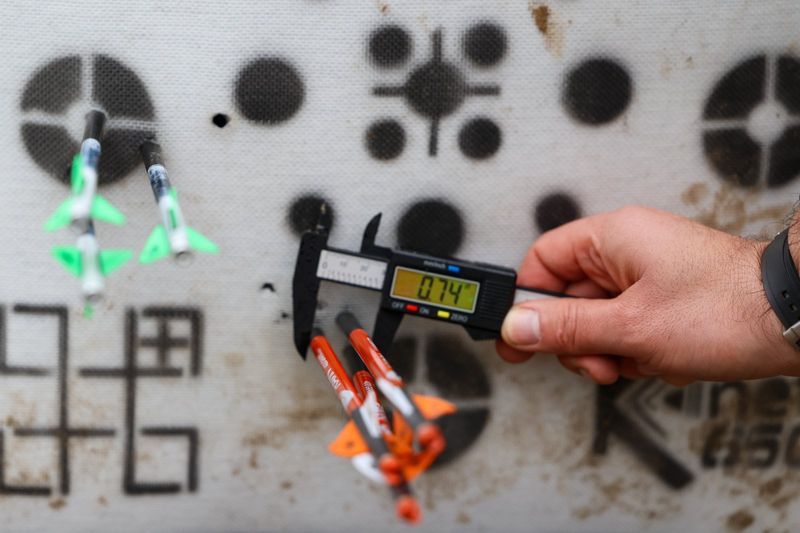 Broadhead arrow group on target showing crossbow vs compound bow accuracy comparison