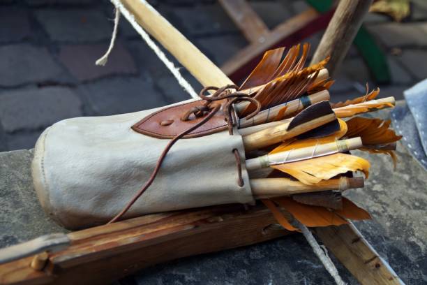 Closeup of an arrow quiver over the bow a closeup of an arrow quiver over the bow bow arrow target closeup stock pictures, ro