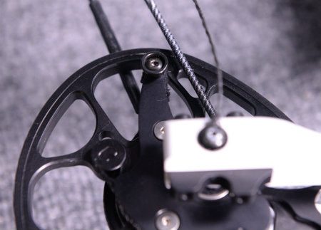 Closeup of a compound bow cam and cable used to evaluate cam timing